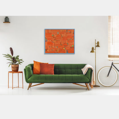 Obraz abstrakcja w tonacji pomarańczowej w pokoju nad zieloną kanapą
